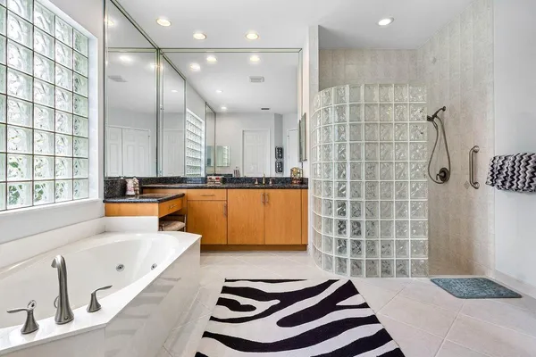 a bathroom with a bathtub and a shower