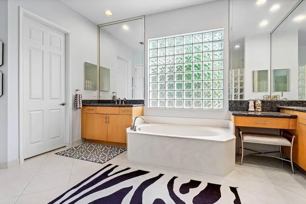 a bathroom with a bathtub a sink and a window