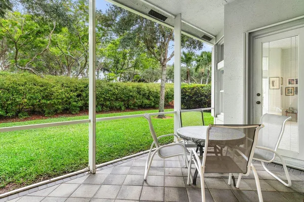 a view of a yard with a table and chairs