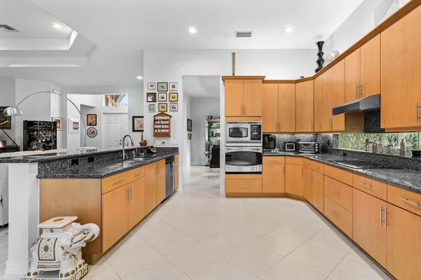 a large kitchen with stainless steel appliances kitchen island granite countertop a large counter top stainless steel appliances and cabinets