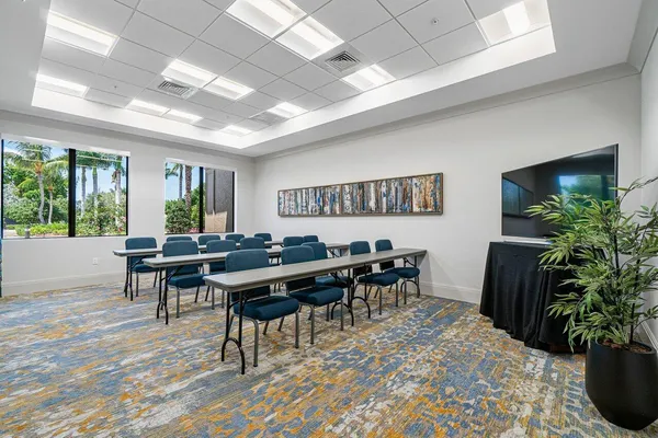 a room with lots of furniture and large windows
