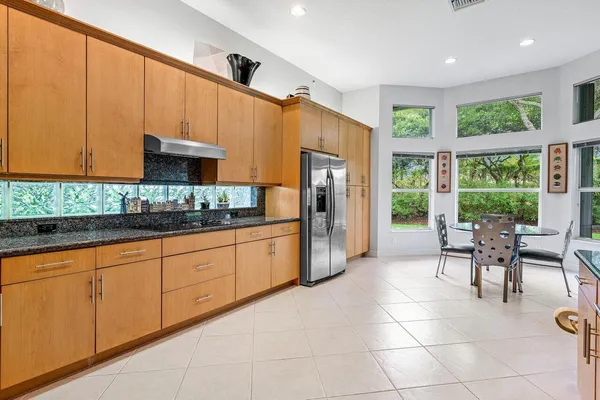 a kitchen with stainless steel appliances granite countertop a refrigerator and a sink