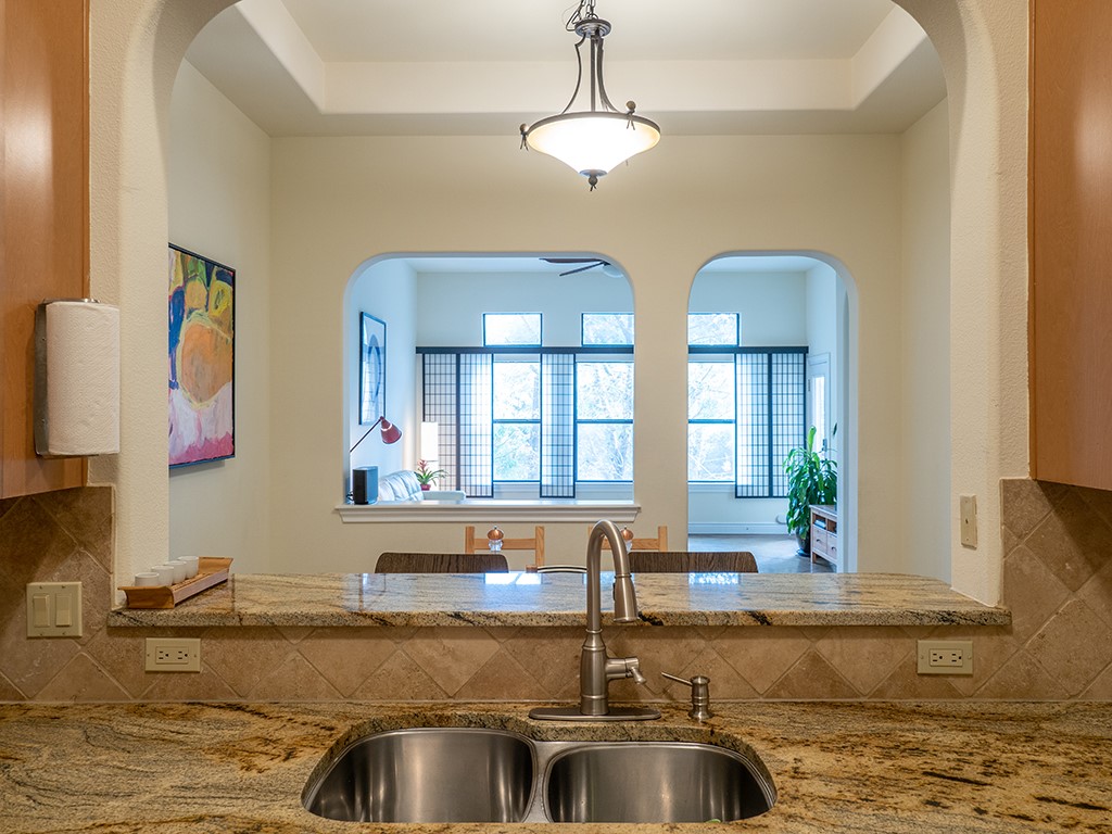 3609 Clawson Road, Unit B Austin, TX 78704 - Photo 9 of 28 Kitchen featuring an undermount double-basin stainless steel sink, a high-arc pull-down faucet, and a stone countertop