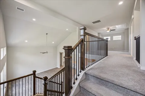 a view of a hallway with stairs