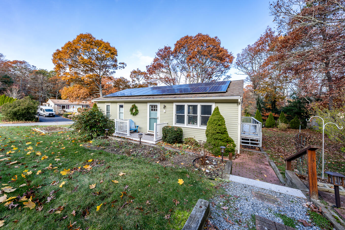 a view of a house with backyard sitting area and garden