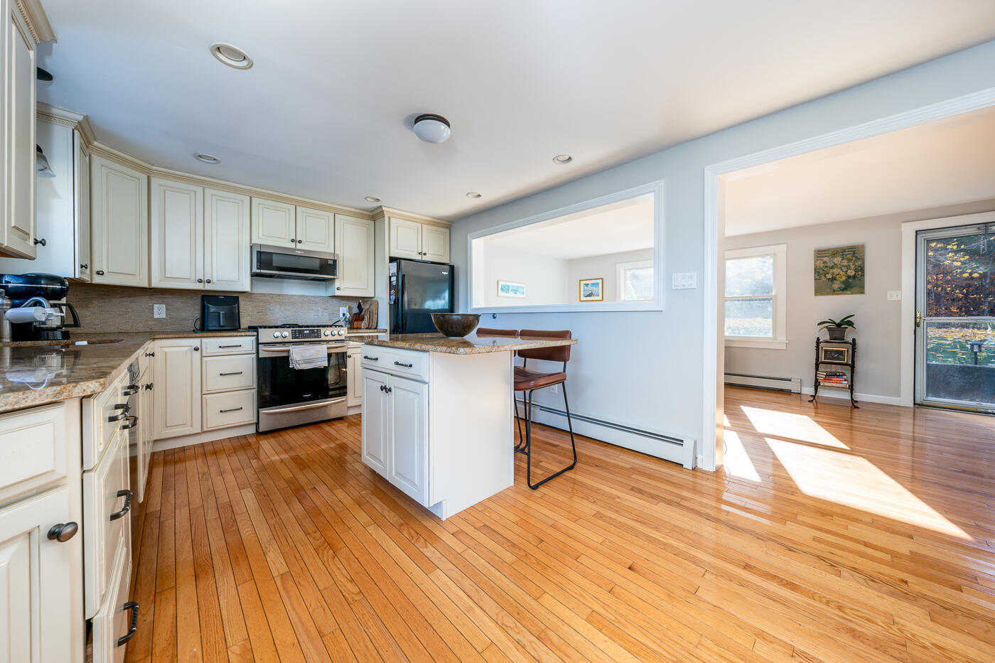 4 Oregon Road Mashpee, MA 02649 - Photo 11 of 31 a kitchen with wooden floors and wooden cabinets