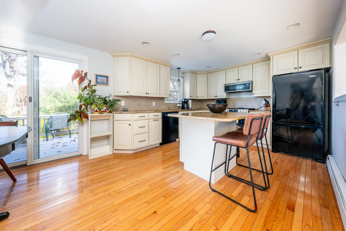 4 Oregon Road Mashpee, MA 02649 - Photo 12 of 31 a kitchen with kitchen island granite countertop wooden floors and stainless steel appliances