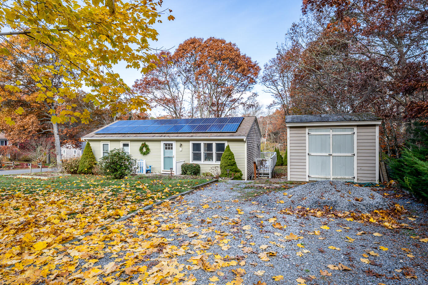 4 Oregon Road Mashpee, MA 02649 - Photo 4 of 31 a front view of a house with a garden