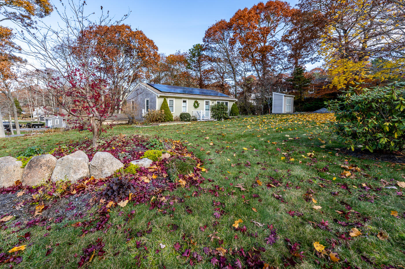 4 Oregon Road Mashpee, MA 02649 - Photo 5 of 31 a front view of a house with a yard and fountain