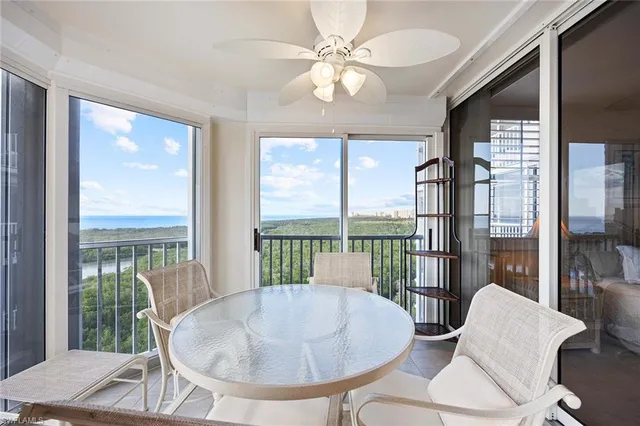 a dining room with furniture a chandelier and wooden floor