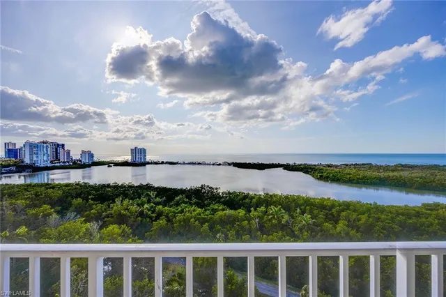 a view of a lake with houses in the back