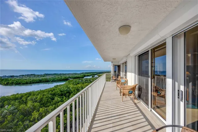 a view of a balcony with chairs and wooden floor