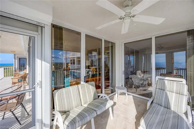 a living room with furniture a ceiling fan and a rug