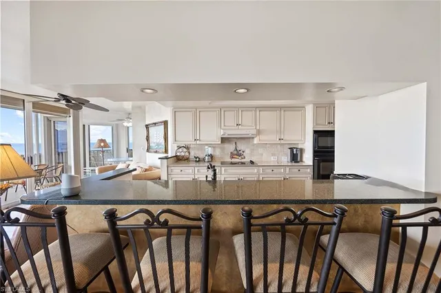 a view of kitchen island kitchen island granite countertop a table and chairs