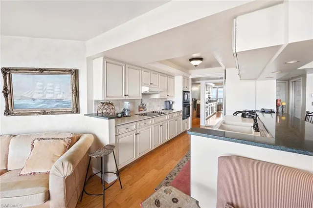 a large white kitchen with a large window