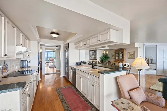 a kitchen with stainless steel appliances granite countertop a stove and cabinets