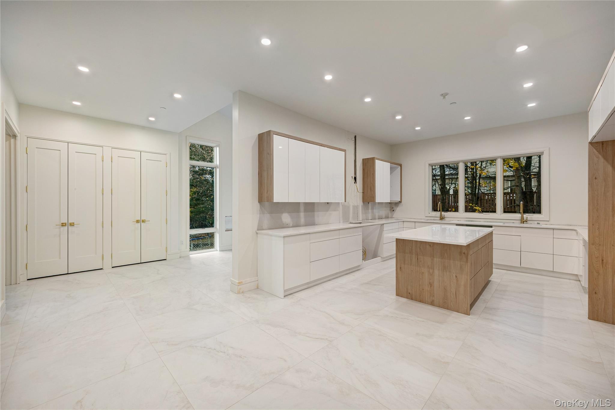 12 Buckman Place, Unit 101 Monsey, NY 10952 - Photo 11 of 50 Kitchen with brown cabinets, modern cabinets, white cabinetry, a center island, and recessed lighting