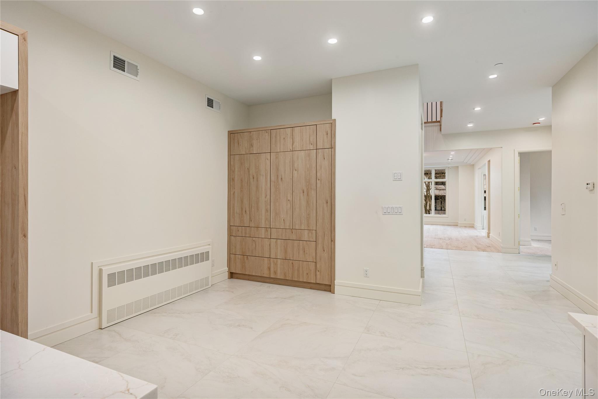 12 Buckman Place, Unit 101 Monsey, NY 10952 - Photo 12 of 50 Unfurnished bedroom with radiator, recessed lighting, and light marble finish floors