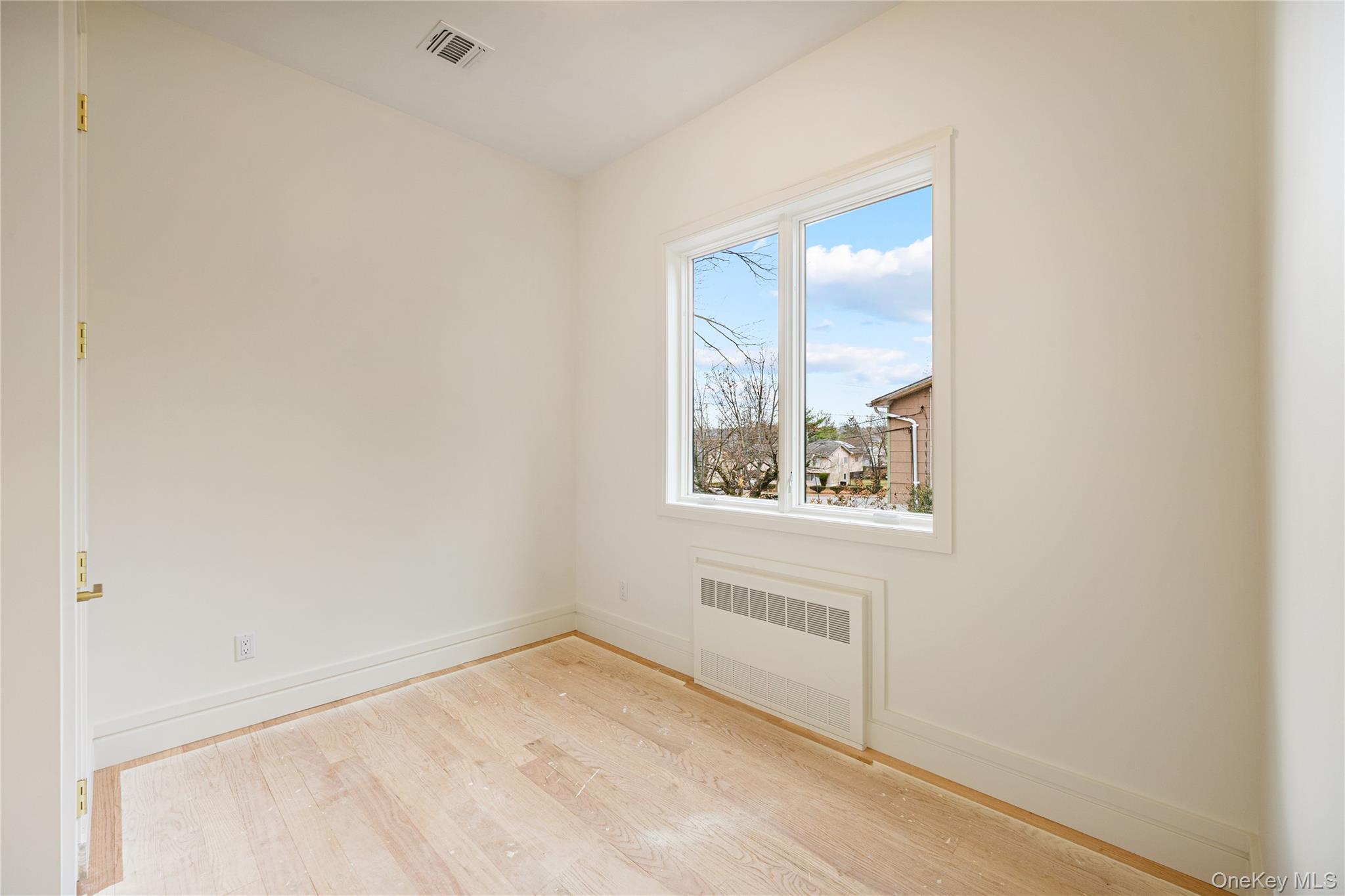 12 Buckman Place, Unit 101 Monsey, NY 10952 - Photo 21 of 50 Unfurnished room featuring light wood finished floors and radiator