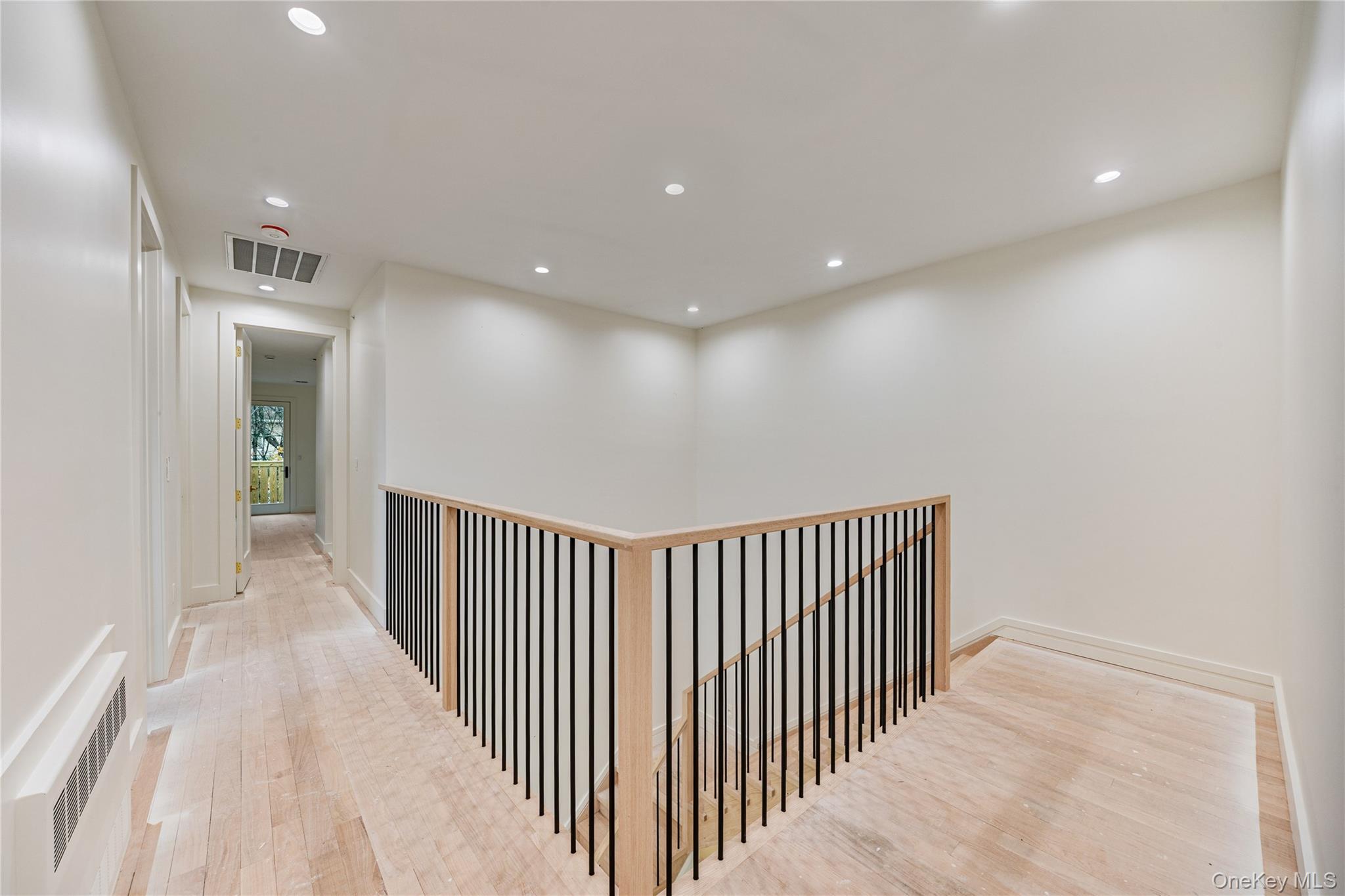 12 Buckman Place, Unit 101 Monsey, NY 10952 - Photo 23 of 50 Corridor with radiator, recessed lighting, an upstairs landing, and light wood-style floors