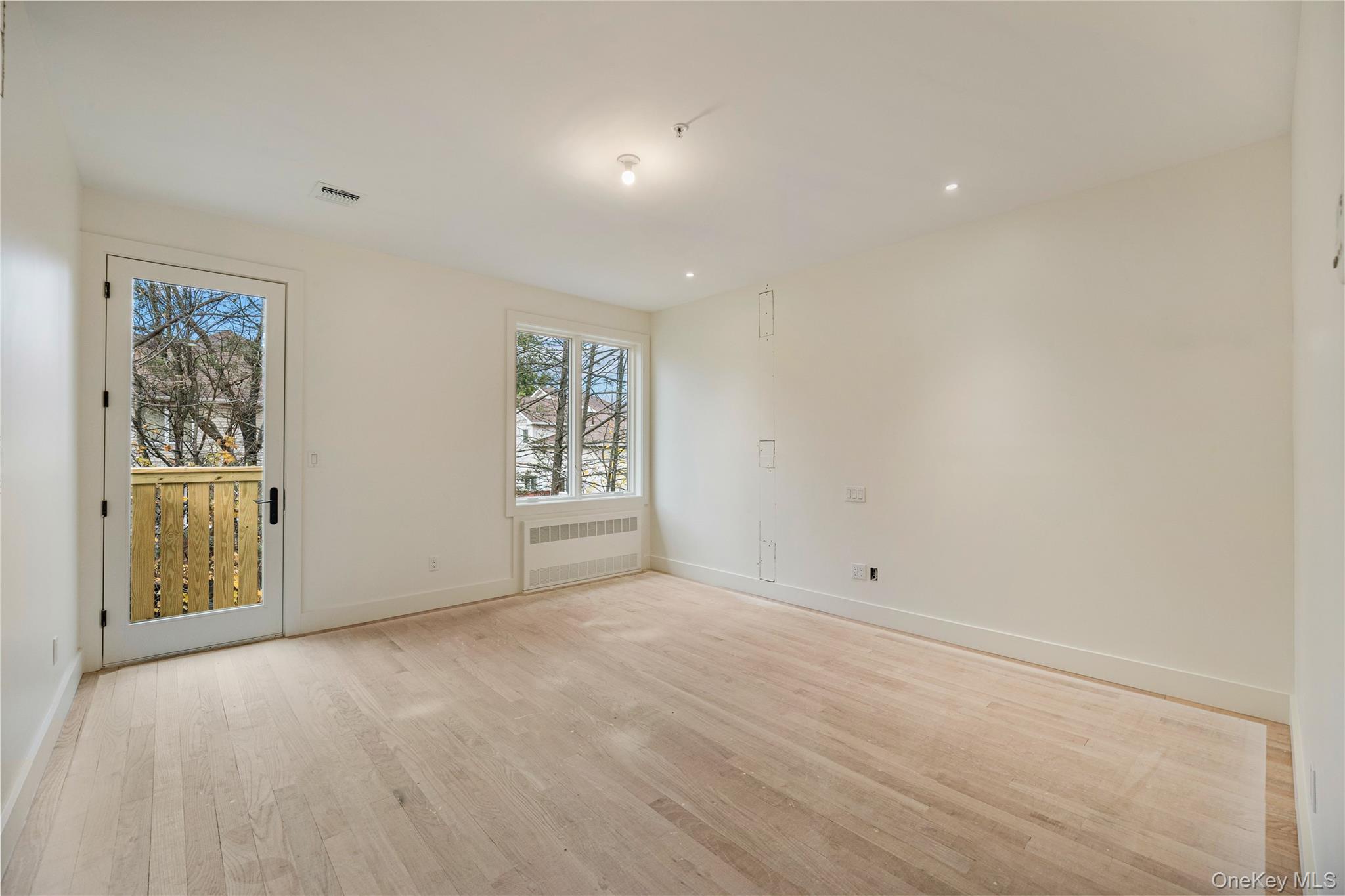 12 Buckman Place, Unit 101 Monsey, NY 10952 - Photo 24 of 50 Unfurnished room with light wood-style flooring, radiator heating unit, and recessed lighting