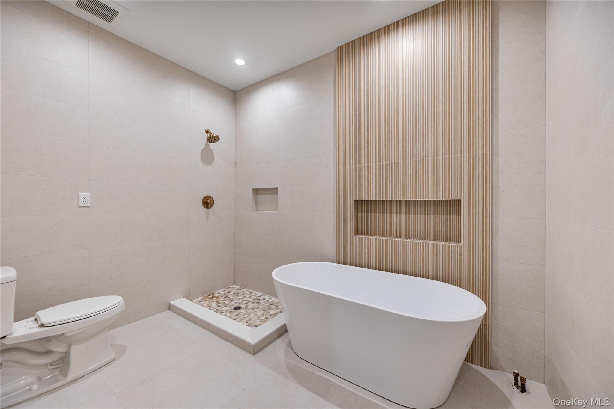 12 Buckman Place, Unit 101 Monsey, NY 10952 - Photo 26 of 50 Full bathroom featuring tile walls, a soaking tub, tile patterned flooring, and recessed lighting