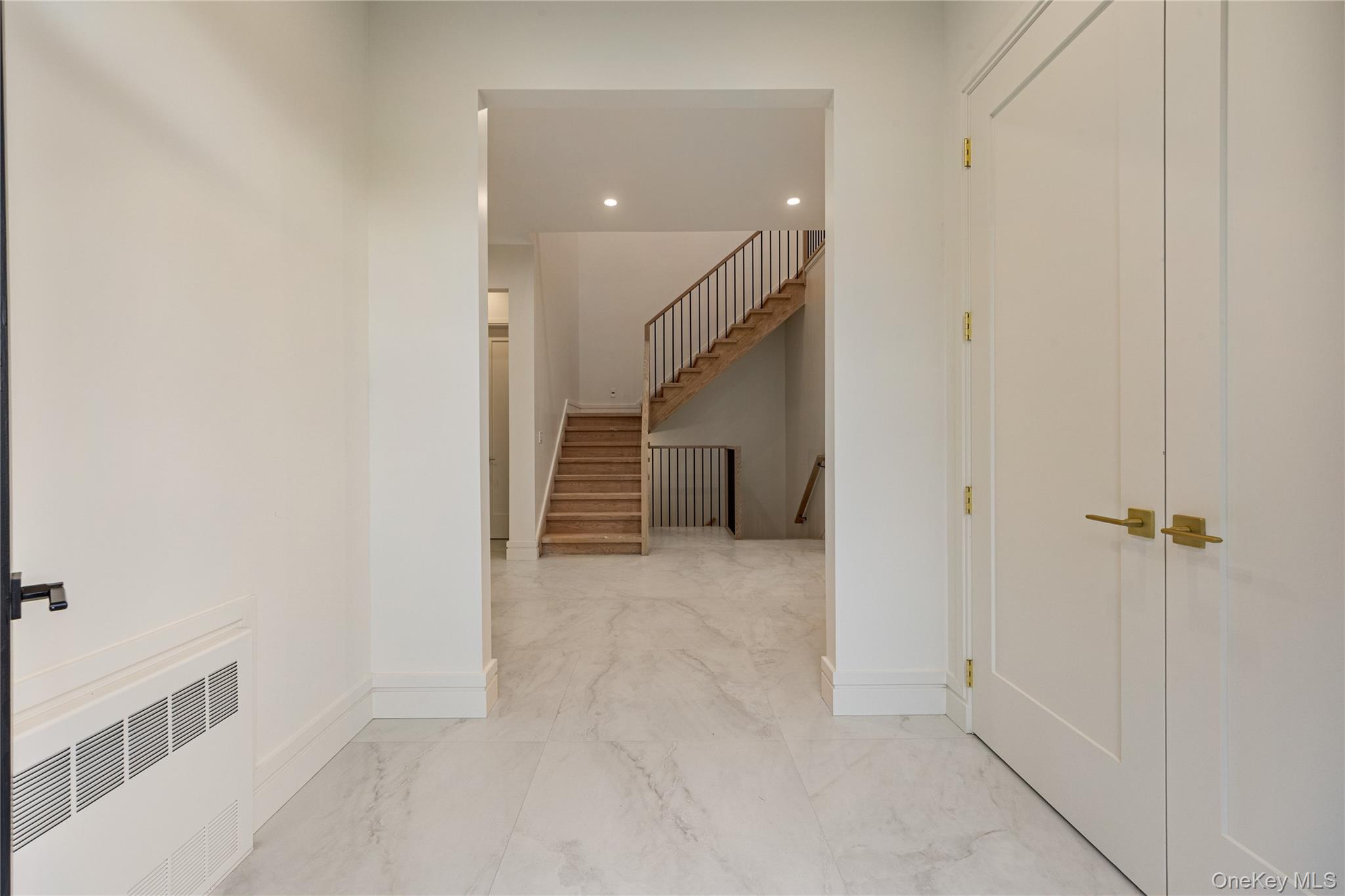 12 Buckman Place, Unit 101 Monsey, NY 10952 - Photo 3 of 50 Hall featuring radiator, recessed lighting, light marble finish floors, and stairway