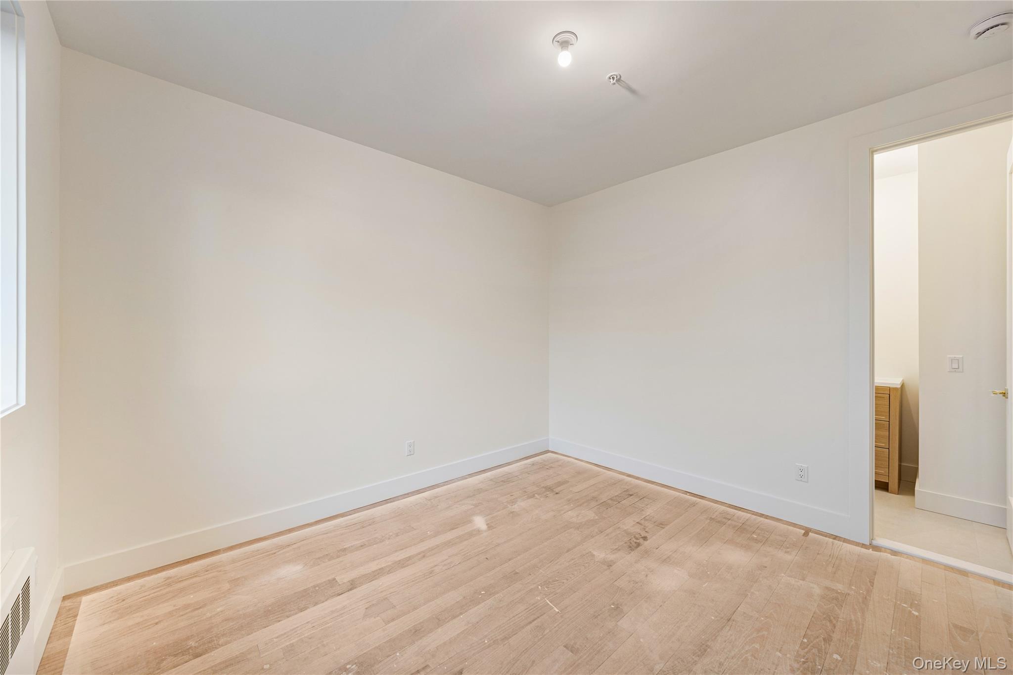 12 Buckman Place, Unit 101 Monsey, NY 10952 - Photo 36 of 50 Unfurnished room featuring light wood-style floors and baseboards