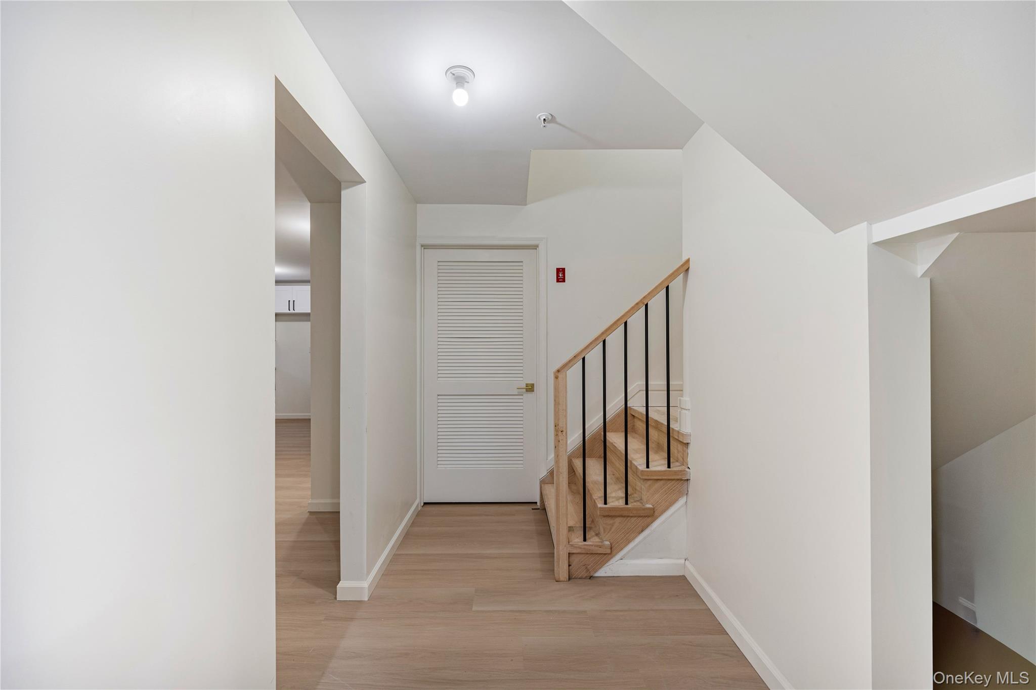 12 Buckman Place, Unit 101 Monsey, NY 10952 - Photo 38 of 50 Hallway featuring light wood finished floors and stairway
