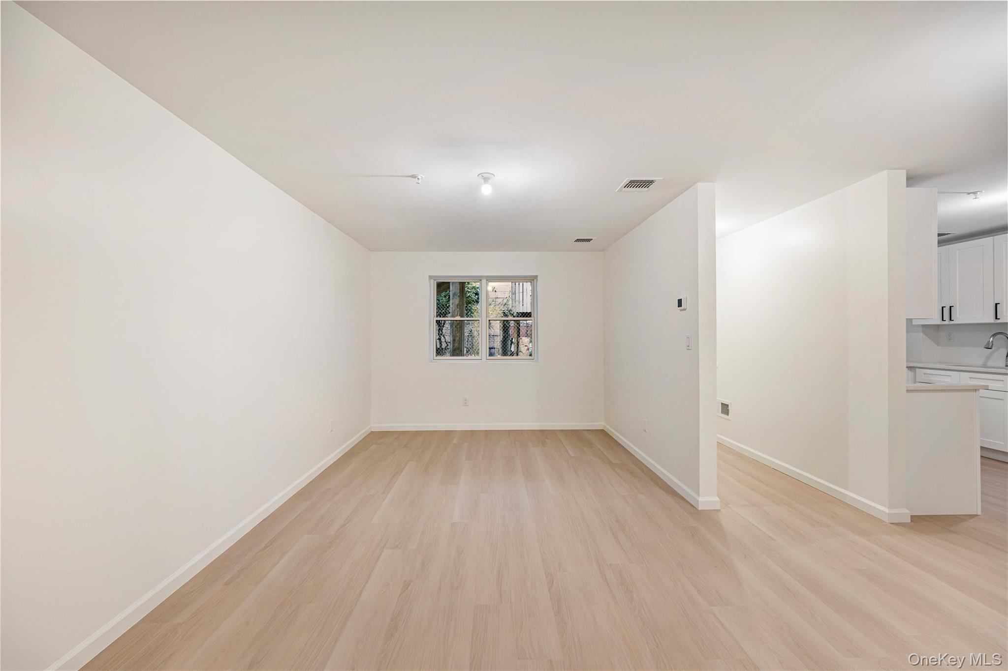 12 Buckman Place, Unit 101 Monsey, NY 10952 - Photo 41 of 50 Unfurnished room with light wood finished floors and baseboards