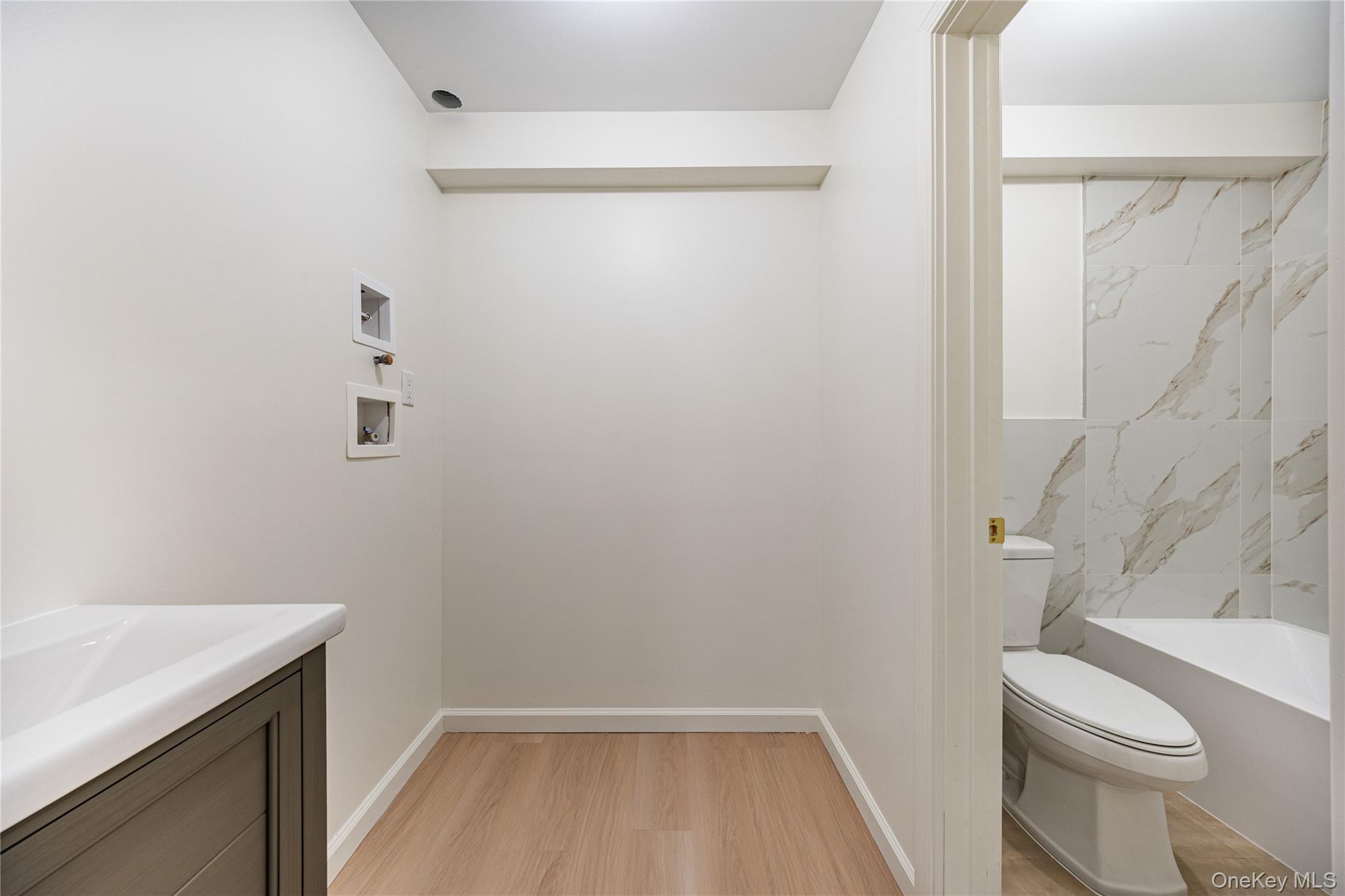 12 Buckman Place, Unit 101 Monsey, NY 10952 - Photo 42 of 50 Full bathroom with vanity, light wood-style flooring, and shower / bath combination