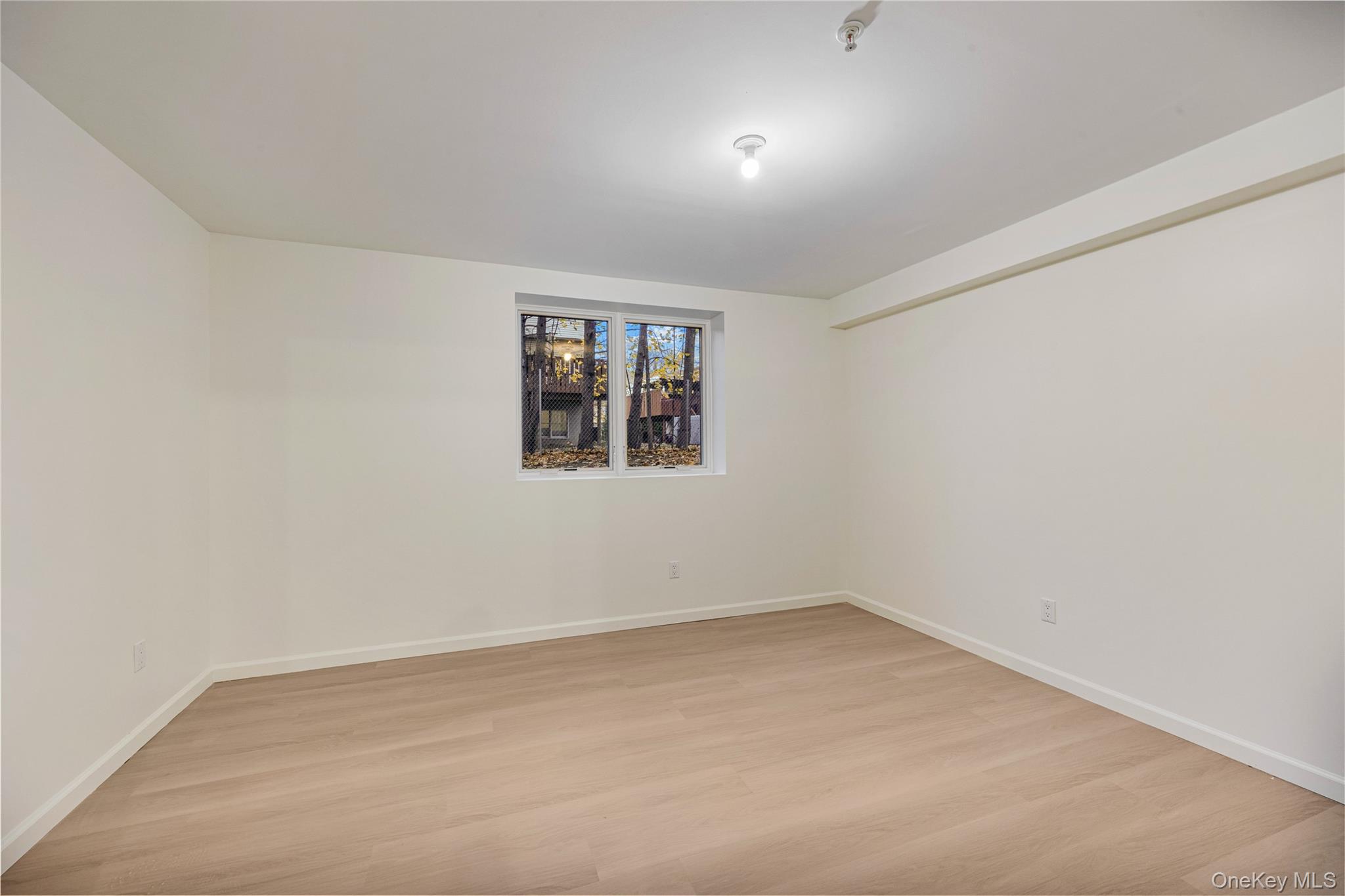 12 Buckman Place, Unit 101 Monsey, NY 10952 - Photo 43 of 50 Unfurnished room featuring light wood finished floors and baseboards