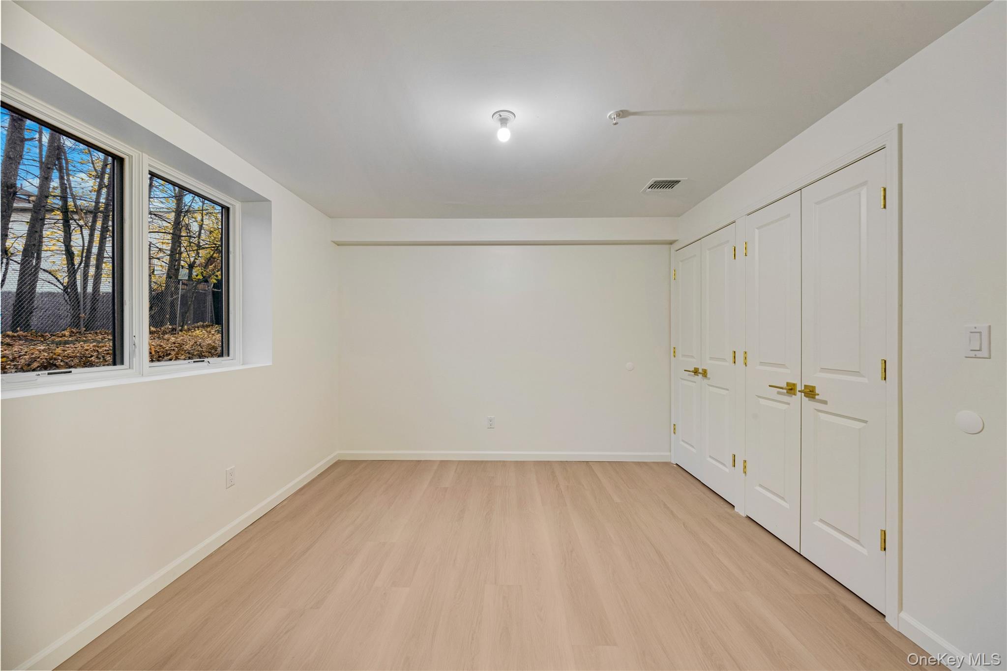 12 Buckman Place, Unit 101 Monsey, NY 10952 - Photo 44 of 50 Unfurnished bedroom featuring light wood-type flooring and baseboards