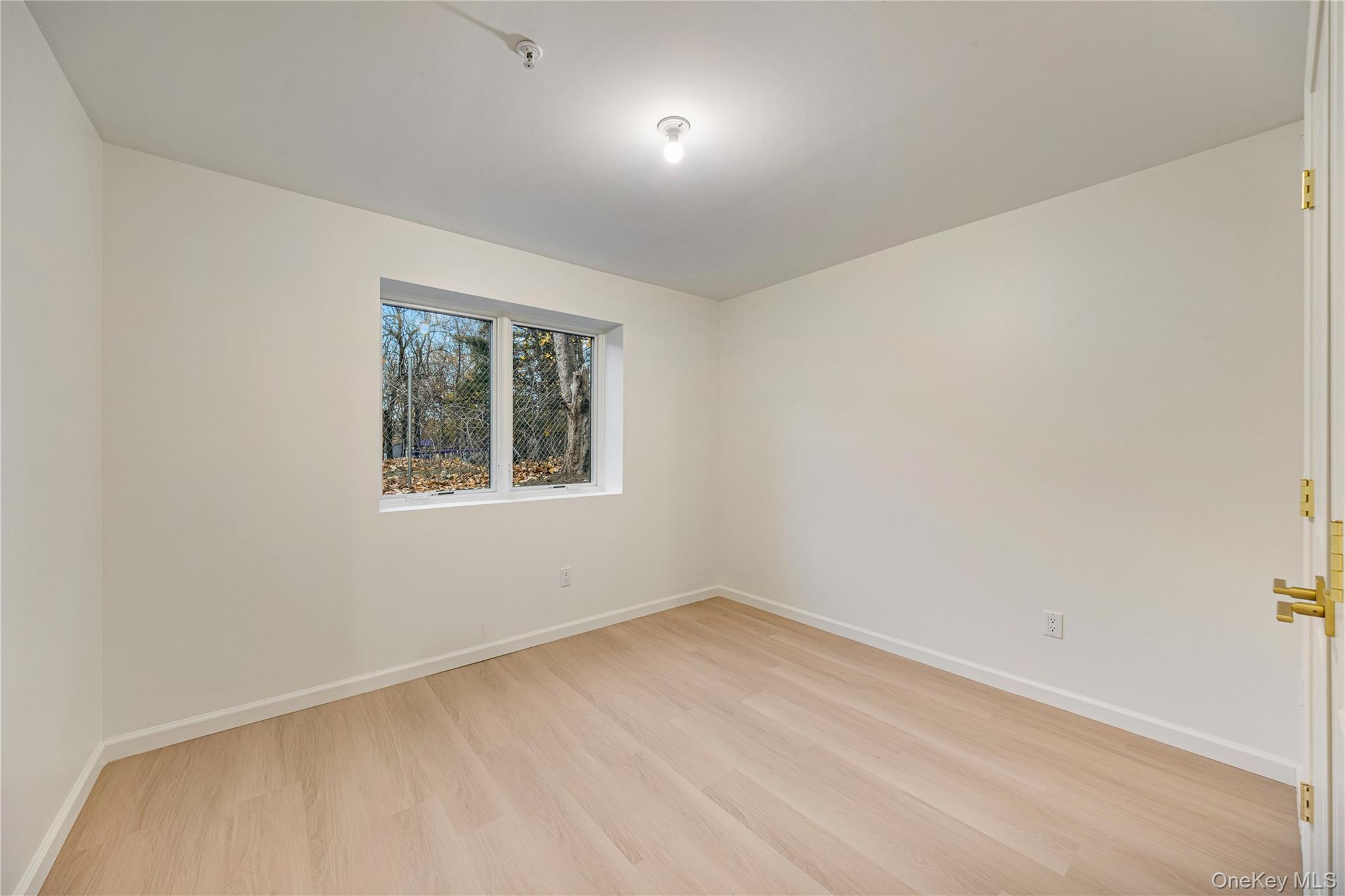 12 Buckman Place, Unit 101 Monsey, NY 10952 - Photo 45 of 50 Unfurnished room with light wood finished floors and baseboards