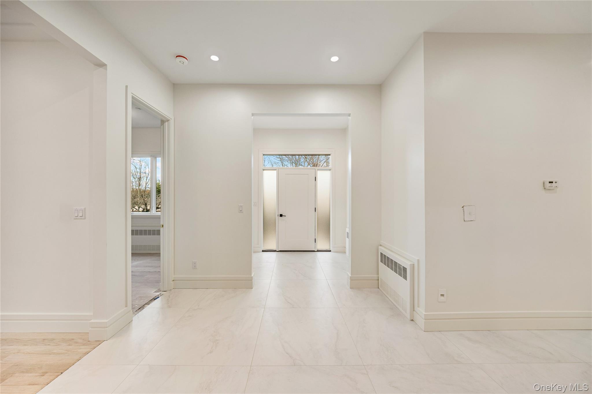 12 Buckman Place, Unit 101 Monsey, NY 10952 - Photo 5 of 50 Hallway featuring radiator heating unit and recessed lighting