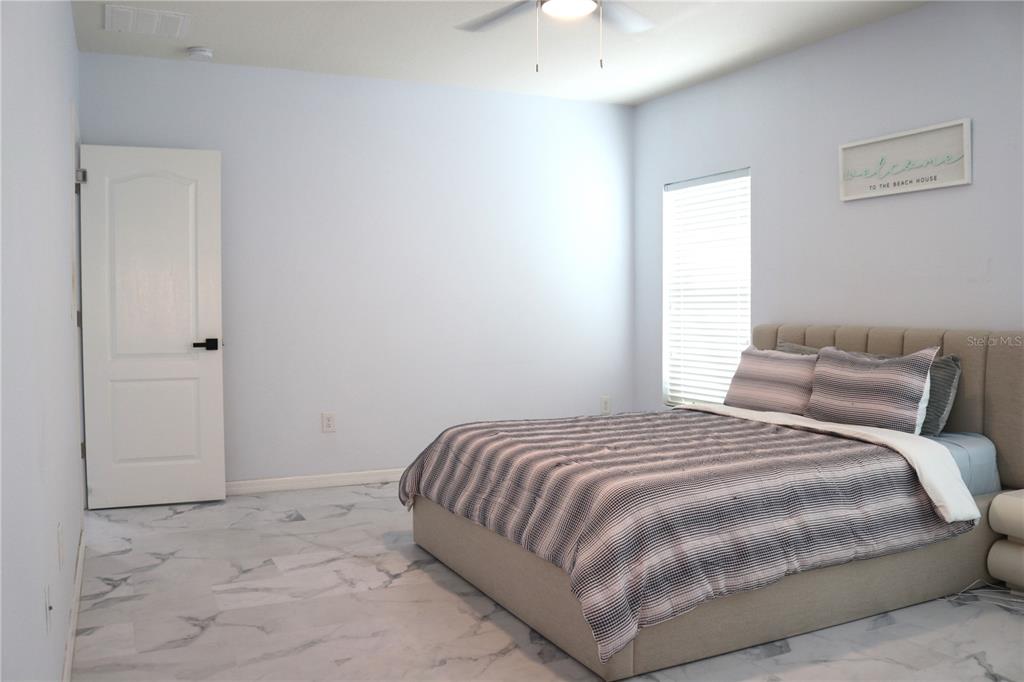 12107 Barnsley Reserve Place Gibsonton, FL 33534 - Photo 12 of 26 a bedroom with a bed and a window