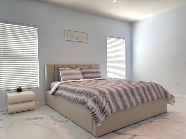 a bedroom with a bed and a couch