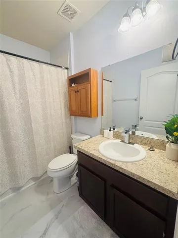 a balcony with table and chairs