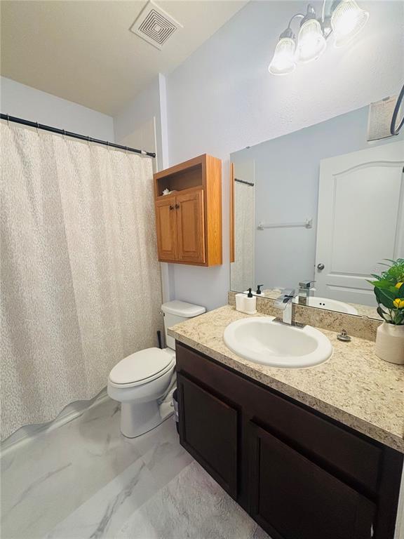 12107 Barnsley Reserve Place Gibsonton, FL 33534 - Photo 18 of 26 a bathroom with a double vanity sink toilet and a mirror