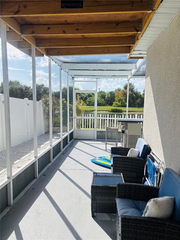 12107 Barnsley Reserve Place Gibsonton, FL 33534 - Photo 20 of 26 a living room with furniture and a floor to ceiling window