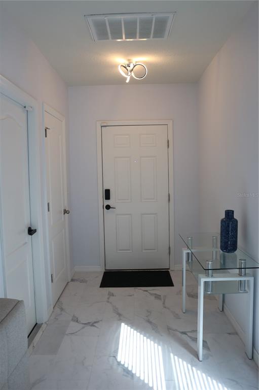 12107 Barnsley Reserve Place Gibsonton, FL 33534 - Photo 2 of 26 a view of a livingroom with a table and chairs