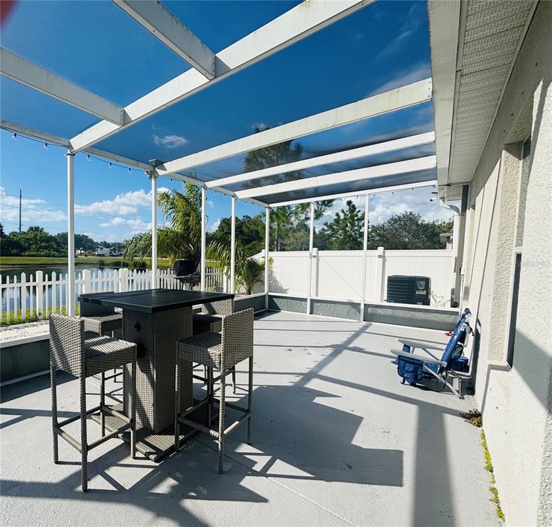 12107 Barnsley Reserve Place Gibsonton, FL 33534 - Photo 21 of 26 a view of a patio with a table chairs and a patio