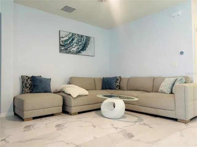 a living room with couches and painting on the wall