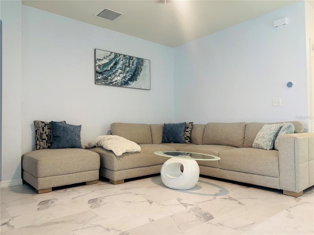 12107 Barnsley Reserve Place Gibsonton, FL 33534 - Photo 4 of 26 a living room with couches and painting on the wall