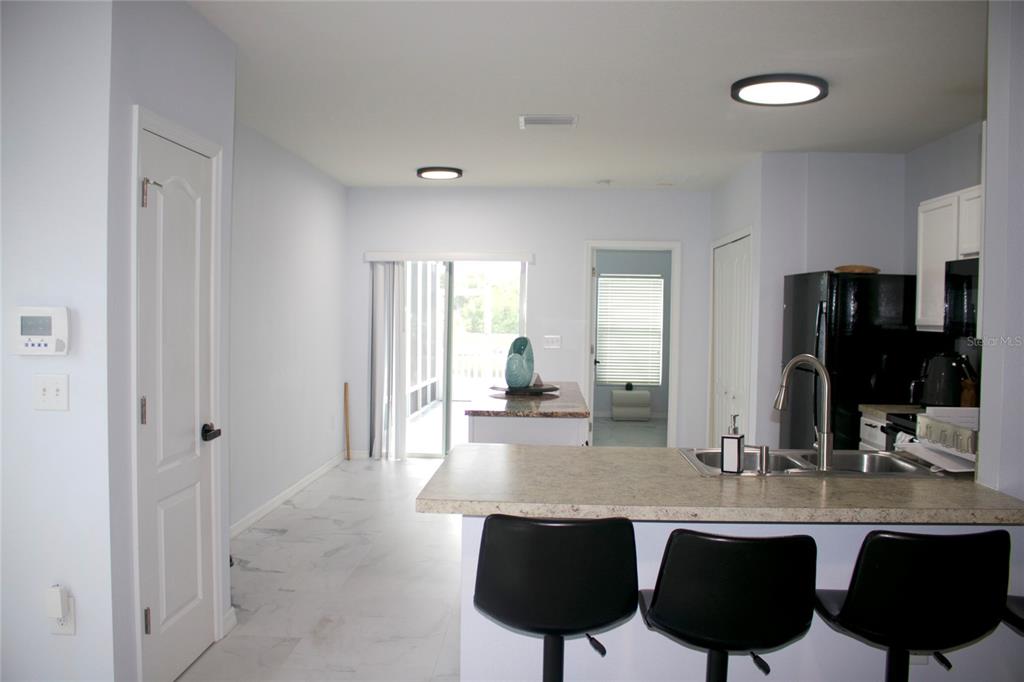 12107 Barnsley Reserve Place Gibsonton, FL 33534 - Photo 6 of 26 a dining hall with stainless steel appliances granite countertop a sink and chairs