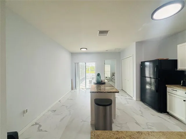 a kitchen with a refrigerator and a sink