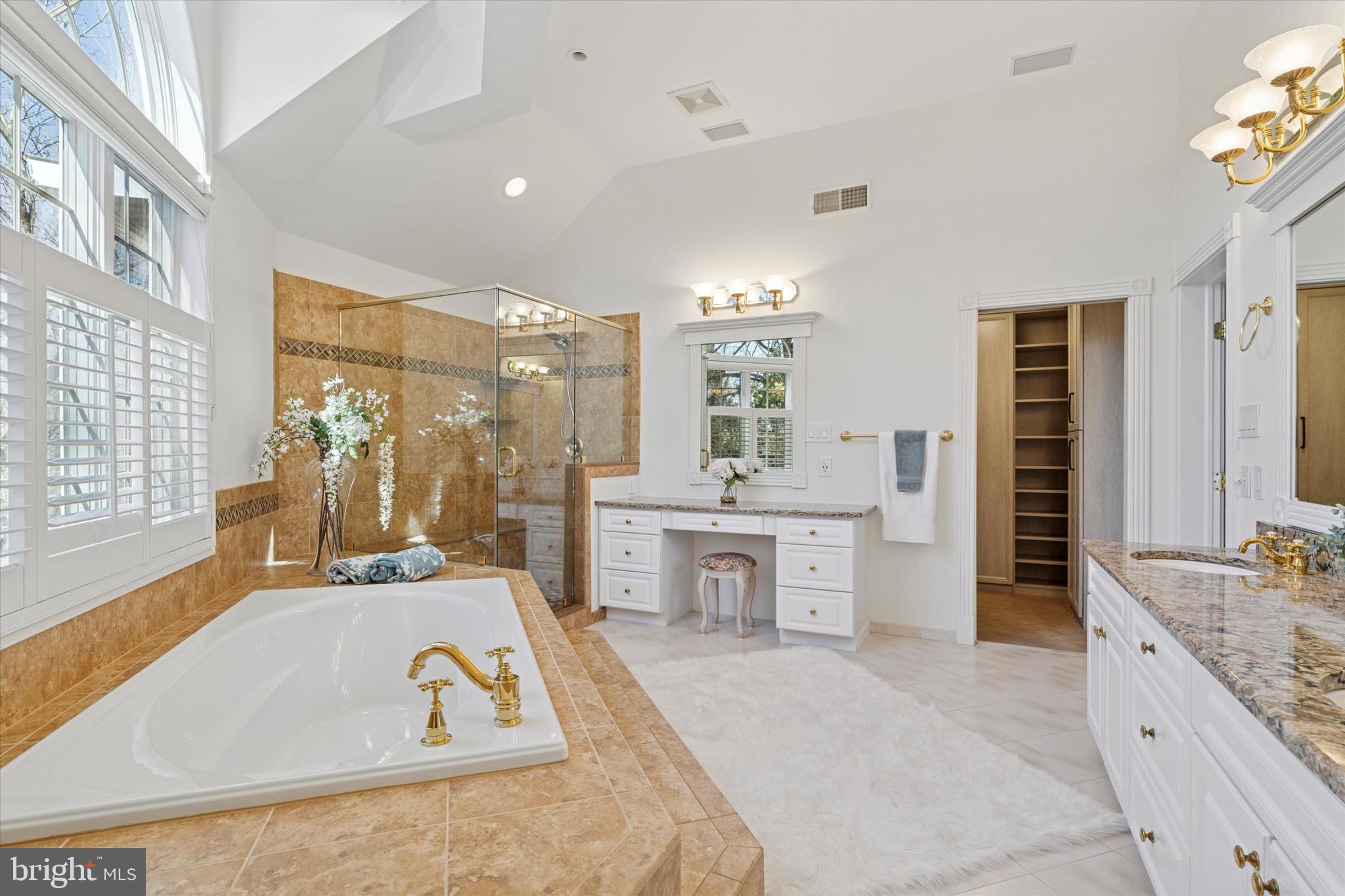 701 Brushtown Road Lower Gwynedd, PA 19002 - Photo 27 of 61 a large bathroom with a tub a double vanity sink a mirror and a shower