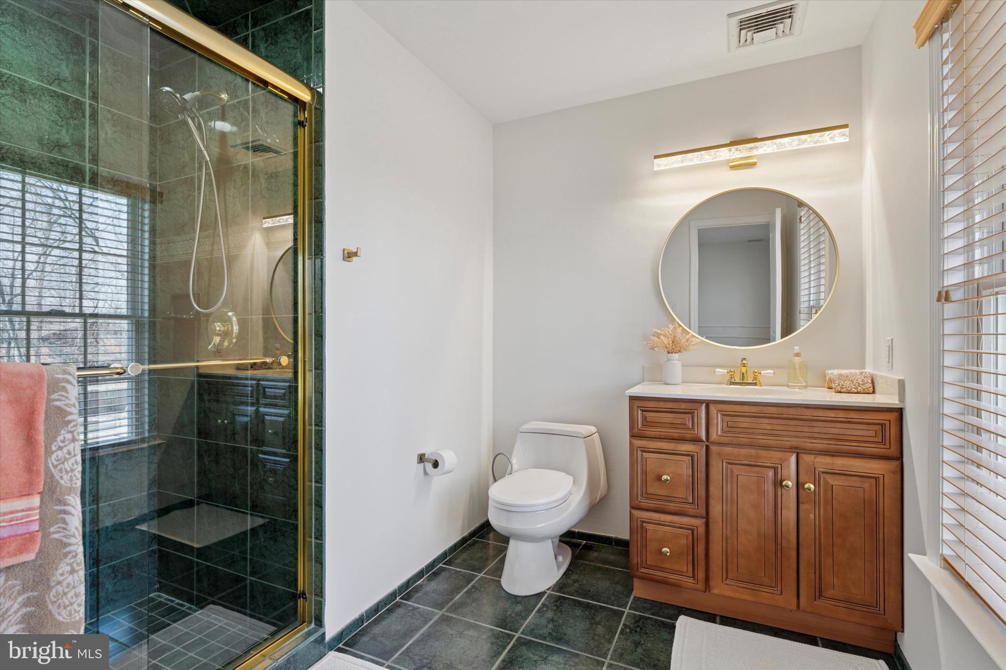701 Brushtown Road Lower Gwynedd, PA 19002 - Photo 33 of 61 a bathroom with a toilet a sink and glass door