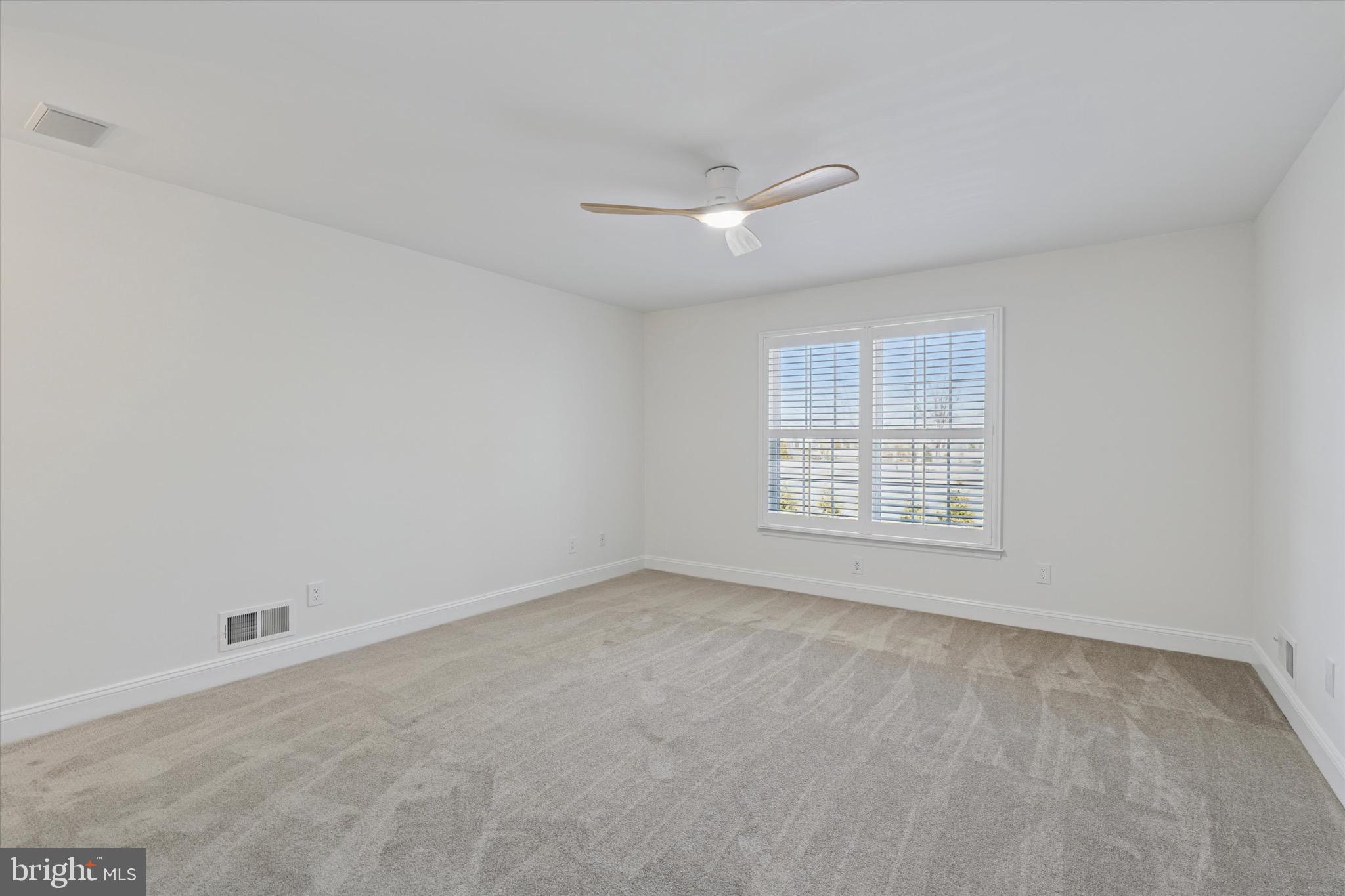 701 Brushtown Road Lower Gwynedd, PA 19002 - Photo 34 of 61 an empty room with a window and ceiling fan
