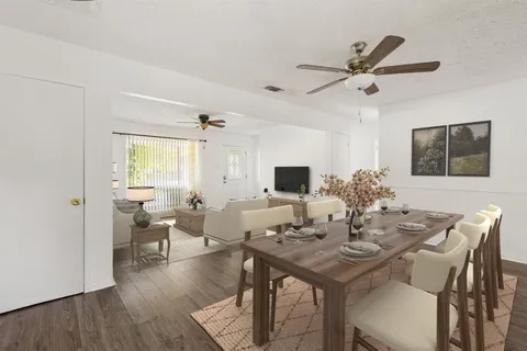 a view of a dining room with furniture and wooden floor
